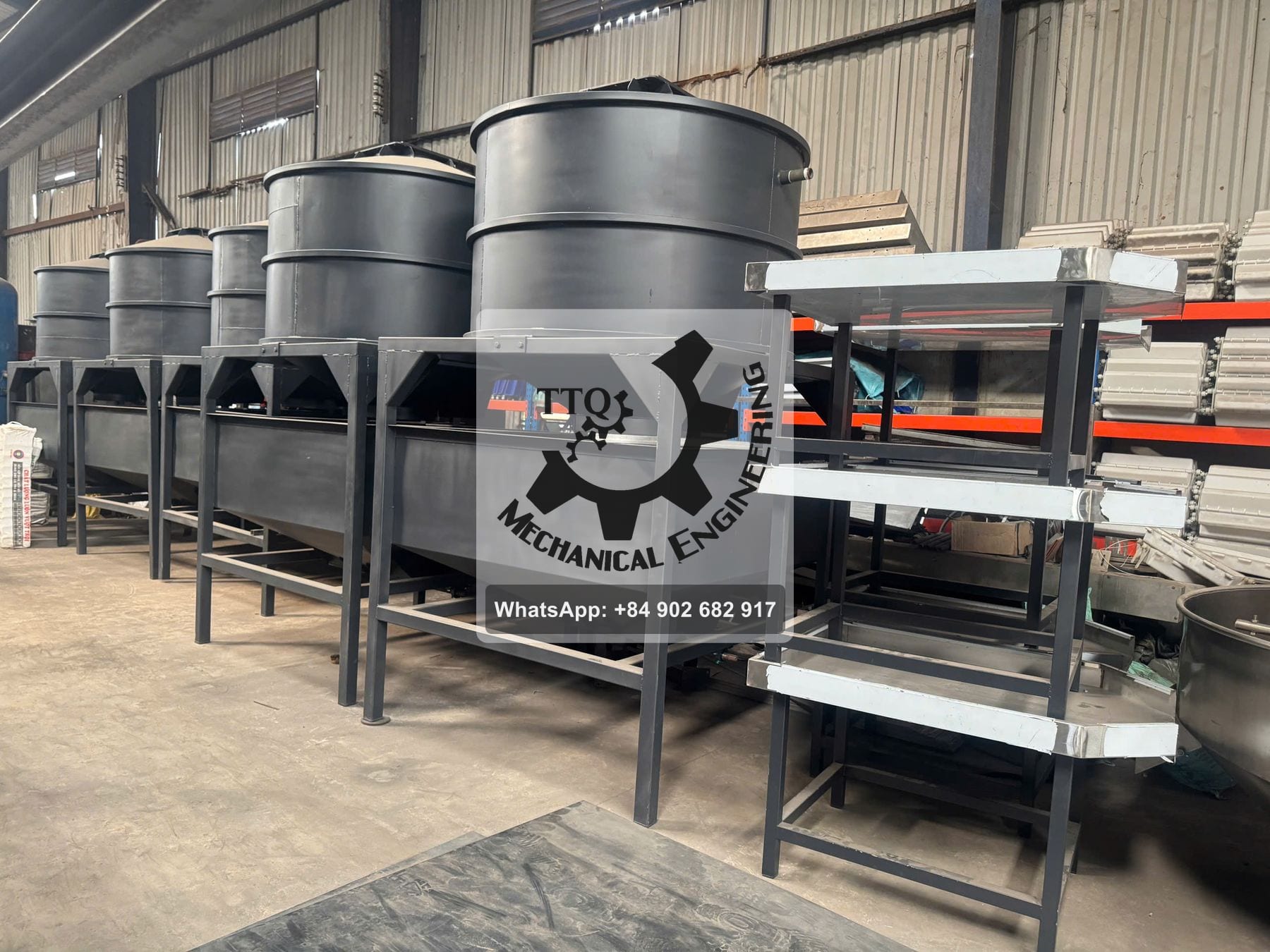 A row of cashew steaming vessels in the TTQ workshop