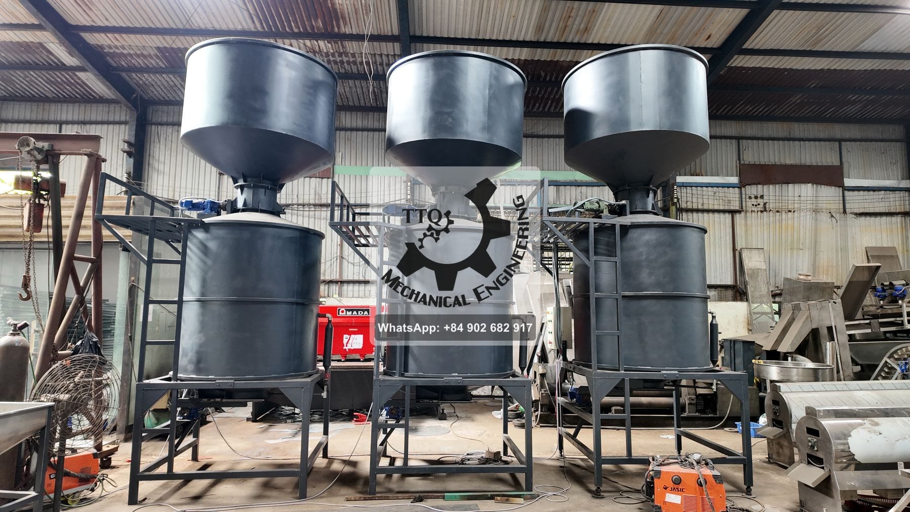 Three TTQ cashew steaming vessels under construction, feed hoppers above the pressure vessels