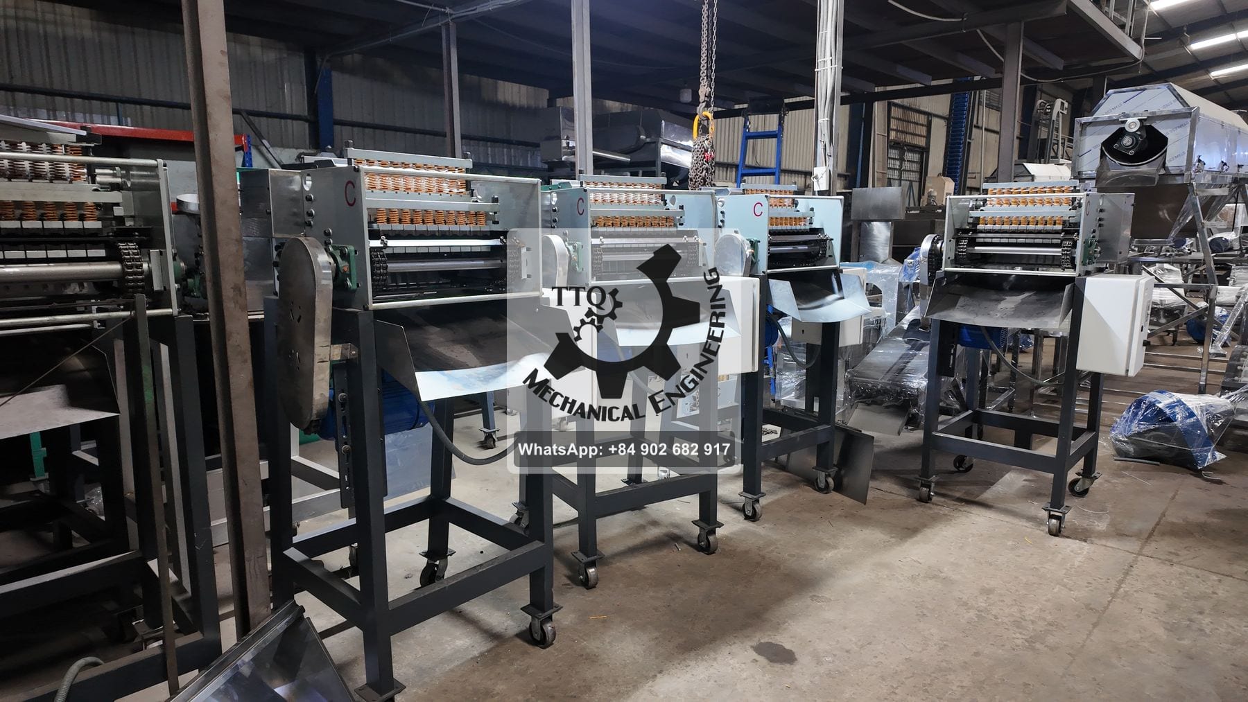 A row of TTQ cashew cutting machines under construction in the workshop