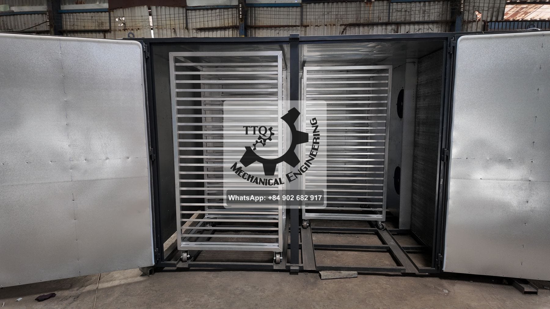 A TTQ humidification chamber with its insulated doors open, two trolleys inside and twin circulation fans