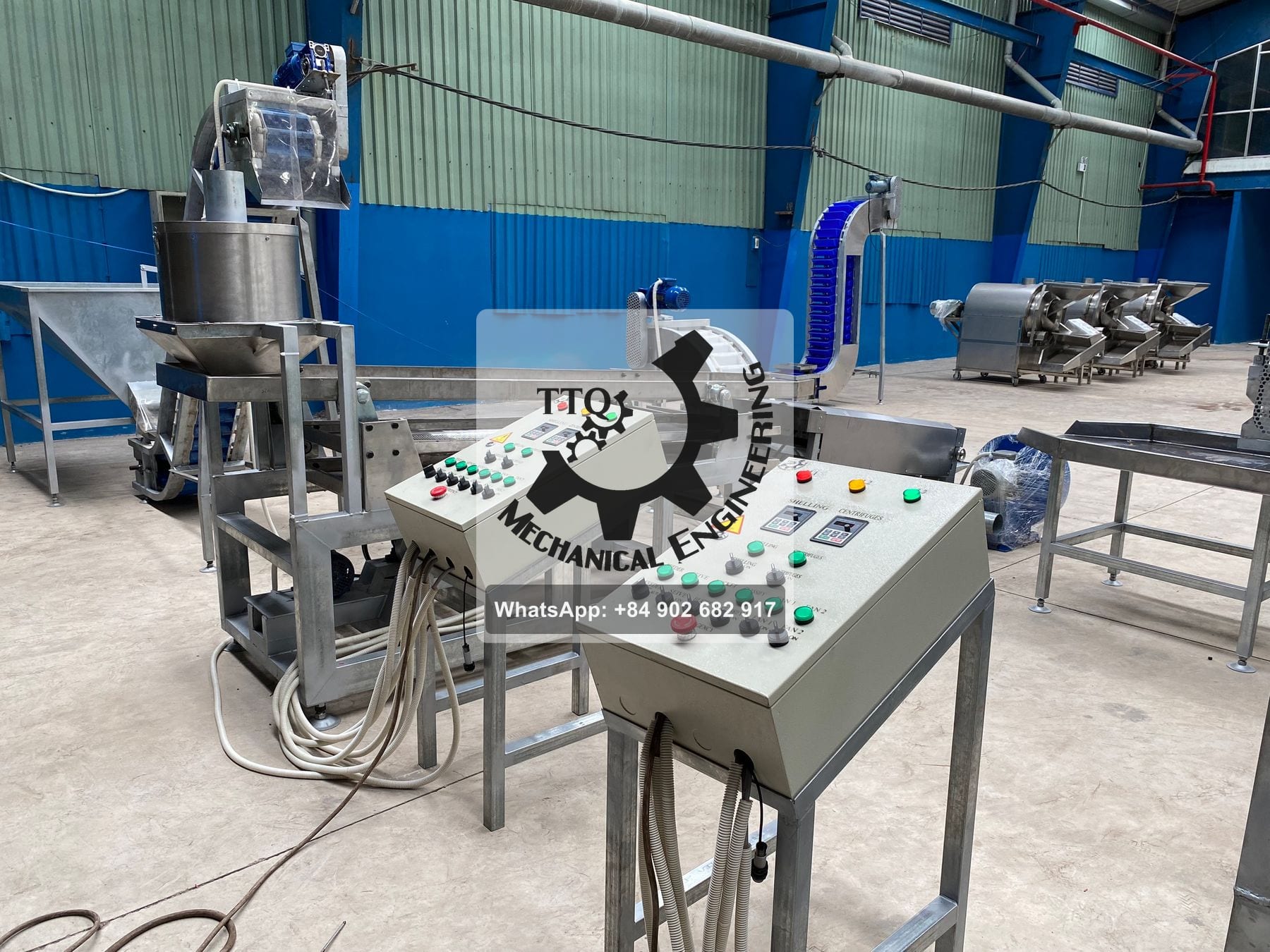A shelling line installed in a plant, with labelled control pedestals for shelling, centrifuges, sieve and fans