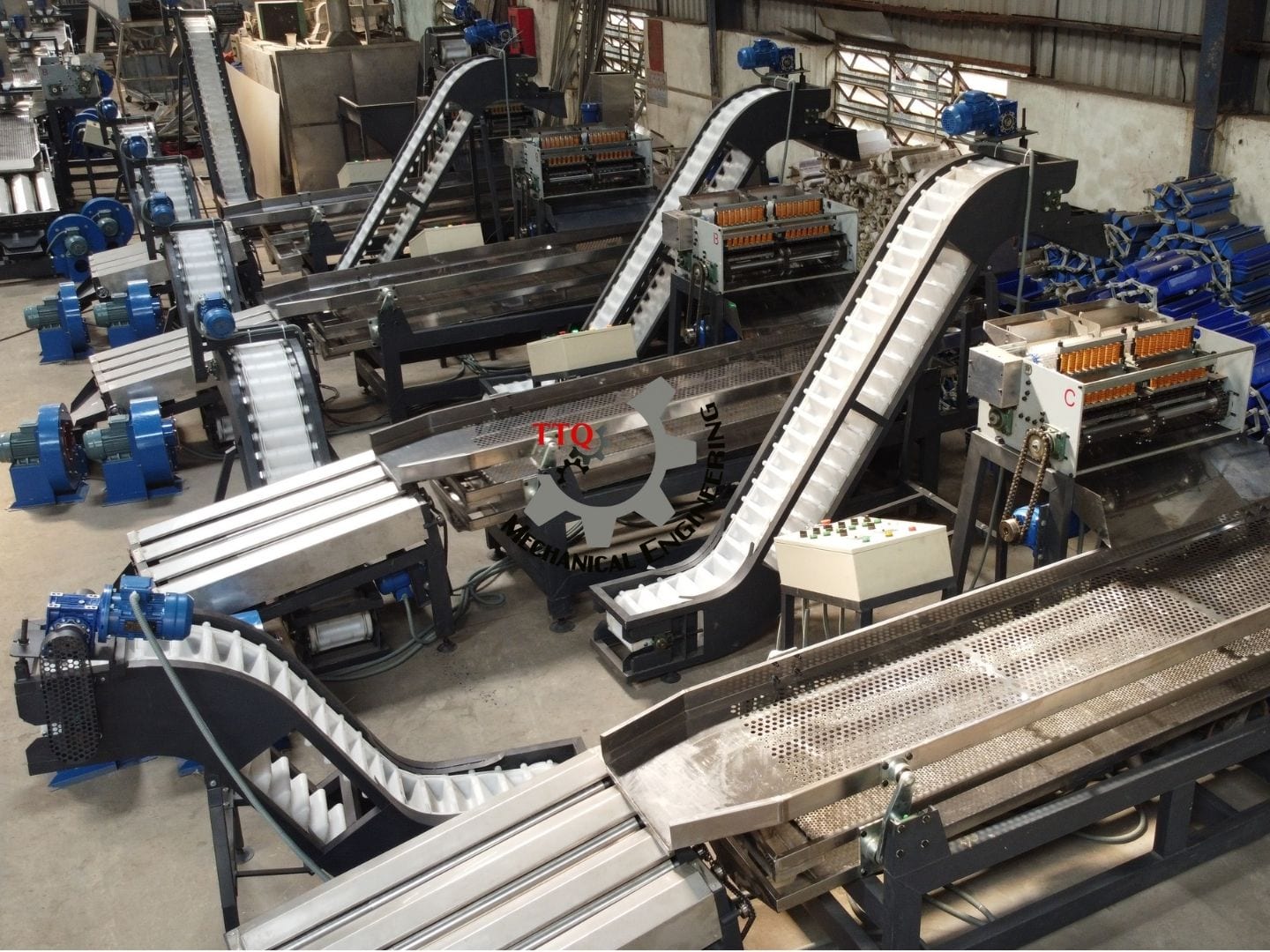 Bucket elevators feeding nuts to the cutting units on TTQ shelling lines